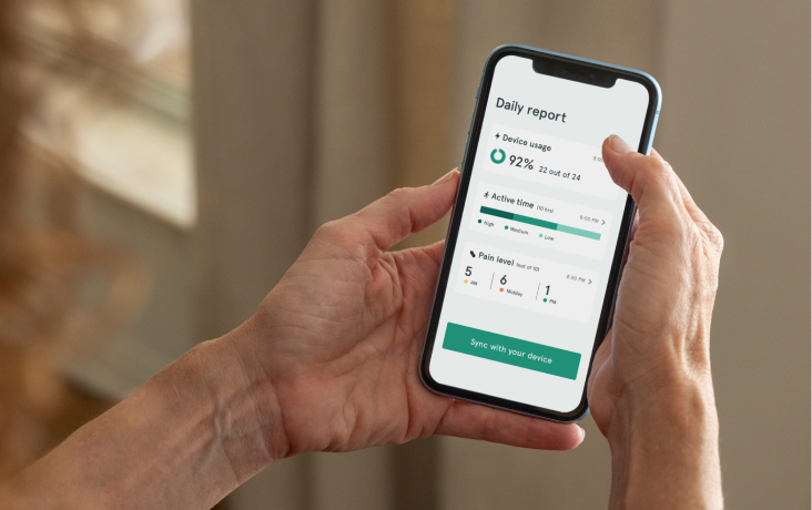 A patient using the ActaStim app to complete her daily system sync.