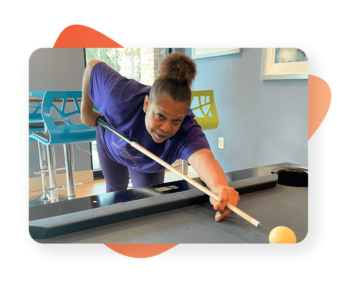 Spinal fusion patient Felicia plays pool to show her improvement with the ActaStim bone growth stimulator