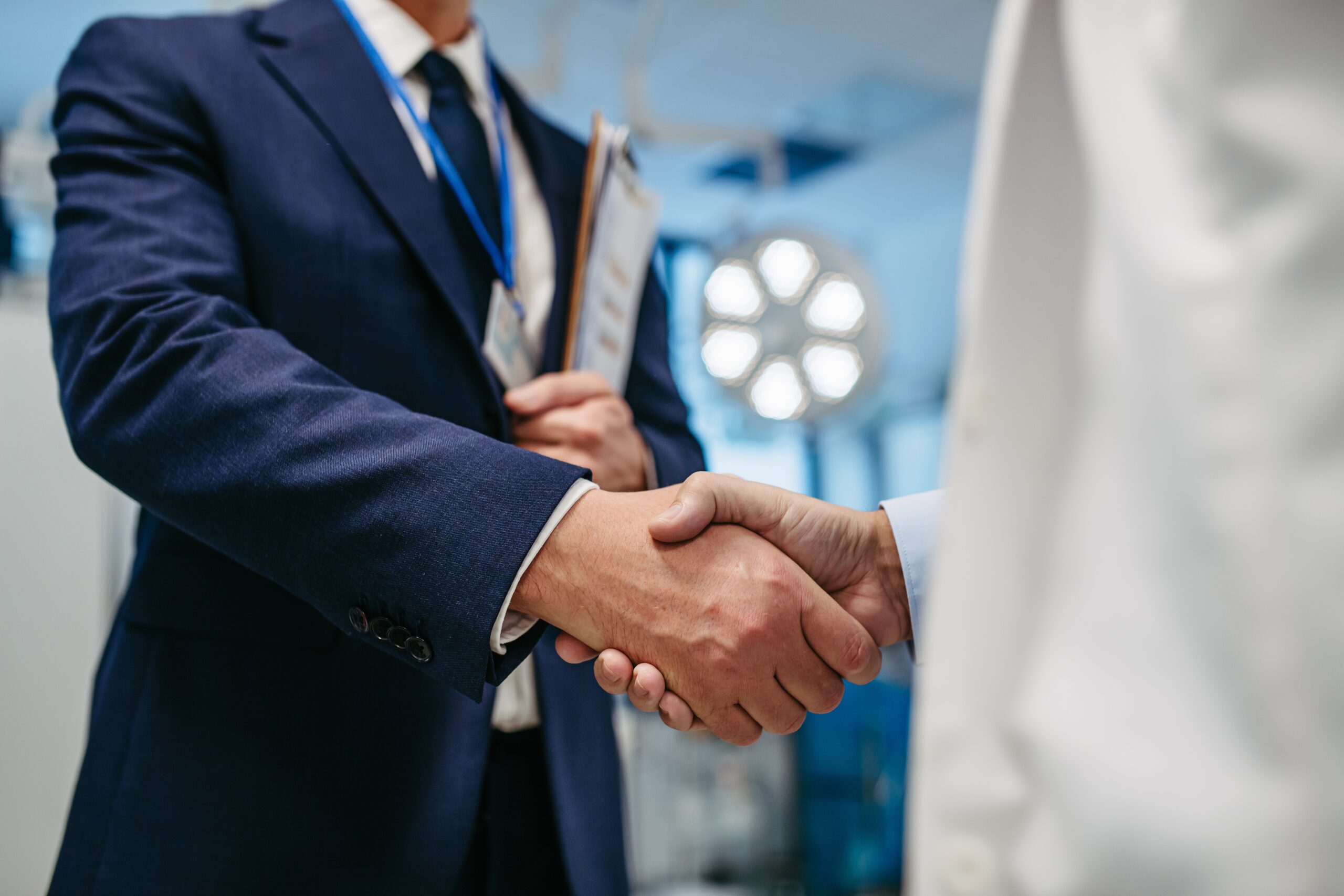 Pharmaceutical,Sales,Representative,Presenting,New,Medication,To,Doctor,In,Medical
